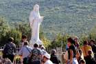 Pilgrims surround a statue of Mary on Apparition Hill in Medjugorje, Bosnia-Herzegovina. 