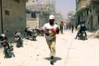 A civil defence member carries an injured girl at a site hit by airstrikes in the rebel-controlled area of Maaret al-Numan, Syria.