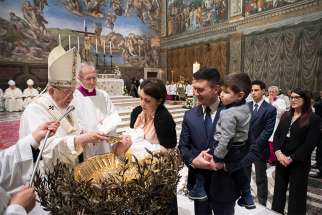 Pope Francis baptizes an infant Jan. 7 in the Vatican&#039;s Sistine Chapel.