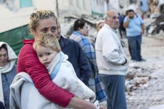 A mother embraces her son in Amatrice, Italy, following an earthquake Aug. 24.