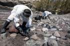 Men collect fuel oil from rocks April 23 following an oil spill along Veneguera beach in Spain&#039;s Canary Islands. Few papal encyclicals have been as eagerly awaited as Pope Francis&#039; upcoming statement on the environment to be published June 19.