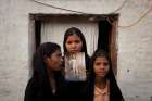 The daughters of Asia Bibi, a Catholic accused of blasphemy, pose in 2010 with an image of their mother while standing outside their residence in Sheikhupura, Pakistan. The Oct. 31 acquittal of Bibi is being challenged in the country&#039;s Supreme Court, according to her husband.