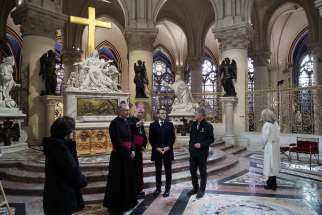 French President Emmanuel Macron, center, is seen during a visit to Notre Dame Cathedral in Paris Nov. 29, 2024. The cathedral is set to reopen in early December, with a planned weekend of ceremonies on Dec. 7 and 8, five years after the 2019 fire that ravaged the world heritage landmark and toppled its spire. Some 250 companies and hundreds of experts were mobilized for the five-year restoration costing hundreds of millions of euros.