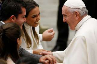 Pope Francis greets a newly married couple during his general audience in Paul VI hall at the Vatican Dec. 11, 2019.