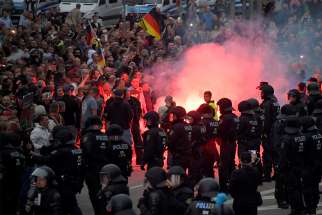 German riot policemen stand guard during a protest Aug. 27 in Chemnitz after a man was stabbed to death. German church leaders condemned anti-immigrant riots in Chemnitz, which erupted after a German man was killed in a brawl with migrants.