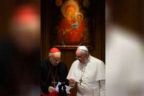 Pope Francis talks with Italian Cardinal Lorenzo Baldisseri, general secretary of the Synod of Bishops, during the morning session on the final day of the extraordinary Synod of Bishops on the family at the Vatican Oct. 18.