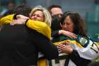 Mourners embrace during an April 8, 2018 vigil at Elgar Petersen Arena in Humboldt, Saskatchewan, to honour members of the Humboldt Broncos junior hockey team who were killed in a fatal bus accident. 