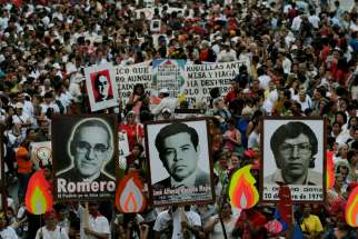 Salvadorans carry a photo of Archbishop Oscar Romero and other victims during a 2008 rally in San Salvador to commemorate the 28th anniversary of their deaths. El Salvador&#039;s Supreme Court declared the country&#039;s amnesty law unconstitutional; human rights defenders say now restorative justice can bring relief to victims.