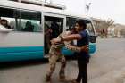 A member of the Iraqi security forces searches a man at a checkpoint in Baghdad June 11. Baghdad will cooperate with Kurdish forces to drive militants out of Mosul, the country&#039;s second-biggest city. Christians are among 500,000 fleeing Mosul after Islam ist forces seized it in early June.