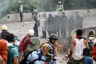 Protesters clash with police June 5 in Caracas, Venezuela. The Vatican indicated June 13 that it supports new elections to solve the country&#039;s crisis.