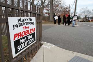 Pro-life advocates participate in a prayer vigil in January near the entrance to a Planned Parenthood clinic in Smithtown, N.Y., that performs abortions. An AP survey shows that the number of abortions has declined in most states. 