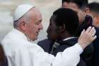 Pope Francis greets a man as he meets the disabled during his general audience in St. Peter&#039;s Square at the Vatican Nov. 15.