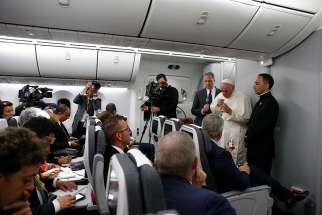 Pope Francis answers questions from journalists aboard his flight from Cartagena, Colombia, to Rome Sept. 10. 
