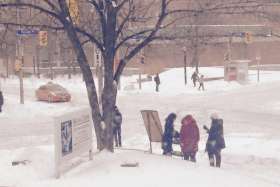 Student campus ministers promoting the Newman Centre by giving away hot beverages and talking to passer-bys.