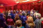 A singer leads the group in a musical prayer inside a red tent on the convention centre floor designated as the Women’s Sacred Space.