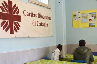 Migrants sit at the Caritas center in Catania, Sicily. The Indian branch of the Catholic social welfare organization, Caritas, has announced plans to fight discrimination and recruit transgender people.