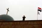 An Iraqi soldier stands guard during Christmas celebrations at the al-Tahira al-Kubra church in al-Hamdaniya, east of Mosul, Dec. 25, 2016.