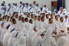 Members of the Missionaries of Charity pray Aug. 26 near the tomb of Blessed Teresa of Calcutta in celebration of her 106th birthday in India. Mother Teresa, founder of the Missionaries of Charity, will be canonized at the Vatican Sept. 4.