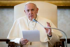 Pope Francis speaks during his general audience as it is livestreamed from the library of the Apostolic Palace at the Vatican March 18, 2020. 