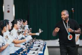 Black Eyed Peas drummer and producer Keith Harris is pictured in an undated photo talking to the handbell choir and choral singers of Sisters of Mary Schools in the Philippines during a recording of a new Christmas song &quot;It&#039;s That Time Of Year&quot; written by Harris, fellow bandmate Filipino-American Apl.de.Ap and David &quot;DQ&quot; Quiñones.