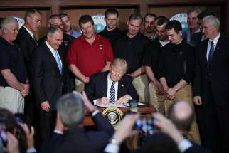 Donald Trump at signing an executive order March 28. The U.S. president signed a bill into law April 13 that allows states to redirect Title X family funding away from abortion clinics.