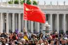 In this file photo, a visitor waves China&#039;s flag as Pope Francis leads his general audience in St. Peter&#039;s Square at the Vatican May 22, 2019.