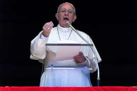 Pope Francis speaks after the &quot;Regina Coeli&quot; prayer April 17 from the window of his studio overlooking St. Peter&#039;s Square at the Vatican. 