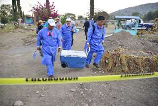 Specialists in Jojutla, Mexico, unearth remains found in unmarked graves March 21.