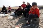 Displaced Kurds stuck at a border near Derik, Syria, wait to try to cross into Iraq Oct. 21, 2019.