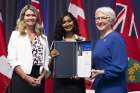 Minister of Education Jill Dunlop, left, along with Lt. Gov. Edith Dumont, present the  Lincoln M. Alexander Award to Rukshika Krishnamoorthy.