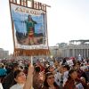 A woman holds a banner honoring St. Kateri Tekakwitha as pilgrims gather for a canonization Mass celebrated by Pope Benedict XVI in St. Peter&#039;s Square at the Vatican Oct. 21. Among the seven people canonized were two North Americans -- St. Kateri, an Ame rican Indian born in upstate New York, and St. Marianne Cope, who worked with leprosy patients on the Hawaiian island of Molokai. 