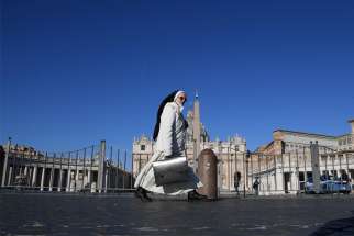 A nun walks next to an empty St. Peter&#039;s Square in Rome during the outbreak of coronavirus March 12, 2020.