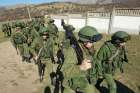 Military personnel, believed to be Russian servicemen, outside a Ukrainian military March 2014. Lithuanian archbishop says his country&#039;s citizens are uneasy about Russia&#039;s military buildup up near its border.