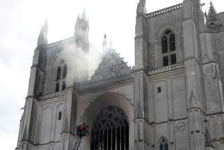 French firefighters battle a blaze at the Cathedral of Sts. Peter and Paul in Nantes July 18, 2020. Police are investigating the incident as arson because the fire started in three different places.