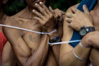 Alleged drug users are arrested with zip ties during a police operation in Quezon City, Philippines, Oct. 5.