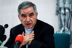 Cardinal Angelo Becciu speaks with journalists during a news conference in Rome in this Sept. 25, 2020, file photo. Vatican prosecutors continued their cross-examination May 18-19 of Cardinal Becciu in a Vatican trial focused on financial malfeasance and mismanagement.