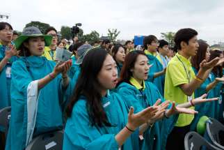 Young people pray as Pope Francis celebrates the closing Mass of the sixth Asian Youth Day at Haemi Castle in Haemi, South Korea, Aug. 17.