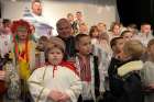 Papal point man for charity, Cardinal Konrad Krajewski, prefect of the Dicastery for the Service of Charity is pictured with children in Fastiv, Ukraine, Dec. 23, 2024, after he opened a soup kitchen in Fastiv, 48 miles west of the Ukrainian capital, Kyiv, and the children performed a Nativity play for him.