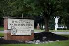 A statue of Christ and a sign are seen in late August at the entrance to the Diocese of Harrisburg in Pennsylvania.