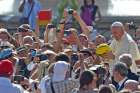 Pope Francis holds a sports ball that was given to him as he arrives for his weekly audience in St. Peter&#039;s Square at the Vatican Aug. 26, 2015.