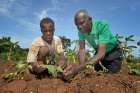 Nigerian Marist Brother Christian Mbam, right, talks with a farmer on a church-sponsored farm in Riimenze, South Sudan. Brother Mbam serves as a technical consultant to a religious-run agricultural project.