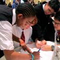 Students from Brebeuf College School work together to create a poster based on their school community and the theme of the Ordinandi Luncheon. This activity is one of the ways that the Ordinandi Luncheon engaged young people.