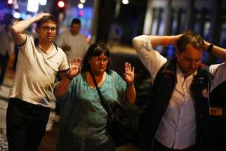 After a terrorist attack near the London Bridge June 3. people leave the area with their hands up. Seven people were killed and dozens injured when three terrorists in a van mowed down pedestrians on the bridge before stabbing a police officer and revelers around Borough Market.