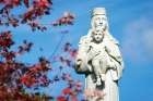 A statue of Mary and the infant Jesus is seen amid fall foliage at Our Lady of the Island Shrine in Manorville, N.Y.