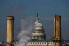 The dome of the U.S. Capitol is seen behind the smokestacks of the only coal-burning power plant in Washington in this March 10, 2014, file photo.