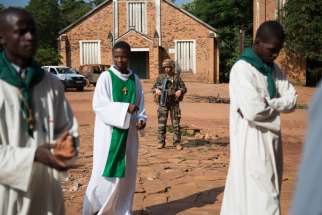 A French soldier stands guard in 2014 outside St. Joseph Cathedral in Bambari, Central African Republic. A church leader confirmed Pope Francis will visit the Central African Republic later this year in an effort to end two years of intercommunal conflict.