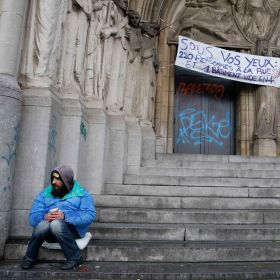 A panhandler sits at the entrance of the an abandoned convent Nov. 4 in Brussels. Pope Francis will help launch a global campaign of prayer and action against world hunger.