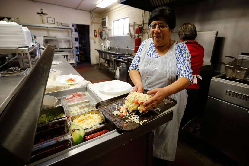 Cook Amelia Patrykus assembles tacos in the kitchen of La Tilma Mexican Grill in mid-February at Sacred Heart Church in El Paso, Texas. The eatery serves up generous plates of homestyle food at value prices.