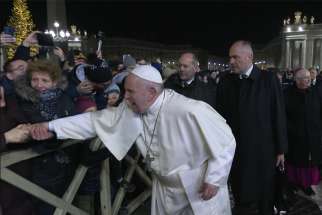 A woman pulls Pope Francis&#039; hand as he greets people while walking to visit the Nativity scene in St. Peter&#039;s Square at the Vatican Dec. 31, 2019. At his Jan. 1 Angelus the pope apologized for the &quot;bad example&quot; he gave when he slapped this woman&#039;s hand.