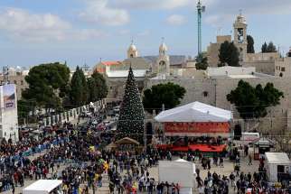 People gather in Manger Square and the Church of Nativity on Christmas Eve in Bethlehem, West Bank.